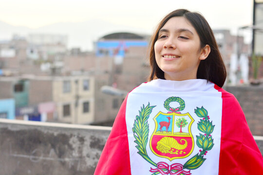 Teenager girl wrapped in peruvian flag.