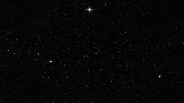 Dense star field in outer space with numerous bright stars scattered