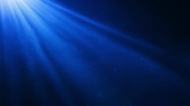 Blue underwater scene with sunlight rays and floating particles
