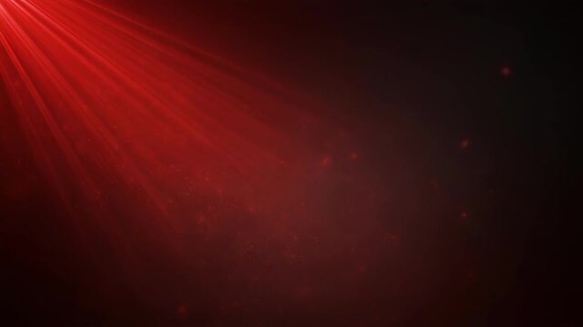 Red light rays shining through particles on a dark background