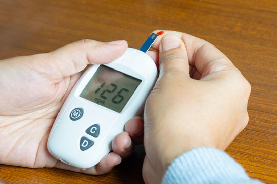 hand of people check diabetes and high blood glucose monitor with digital pressure gauge. Healthcare and Medical concept	

