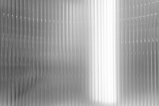 Cinematic Fluted Glass Texture with Luxury Minimalist Light and Shadow for Product Display.