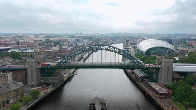 Drone shot iconic arch Tyne Bridge spanning across River Tyne with Glasshouse International Centre for Music, Newcastle