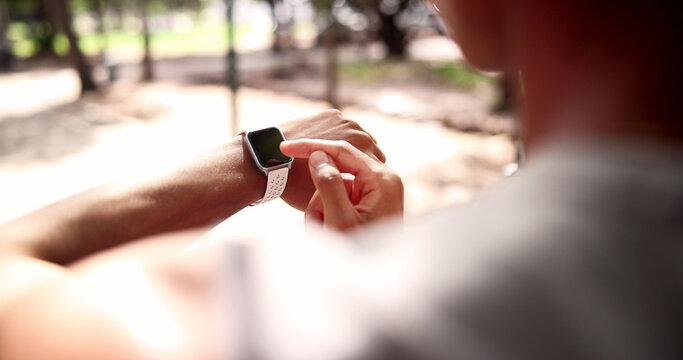 Fitness, man and hands with watch for heart rate, calories or monitoring performance in nature. Active, male person or checking health with wristwatch for step counter, workout app or exercise goals