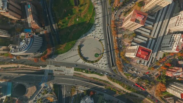 A spiral bird's-eye view of the Monument to Rene Schneider Chereau in Las Condes, Santiago, Chile, on a sunny day