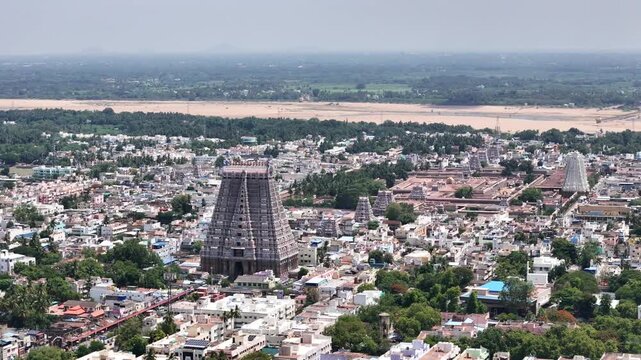 Wide aerial panorama of Sri Ranganathaswamy Temple with its iconic rajagopuram, ancient temple complex, traditional streets, and the scenic Kaveri River captures the spiritual and cultural heart of TN