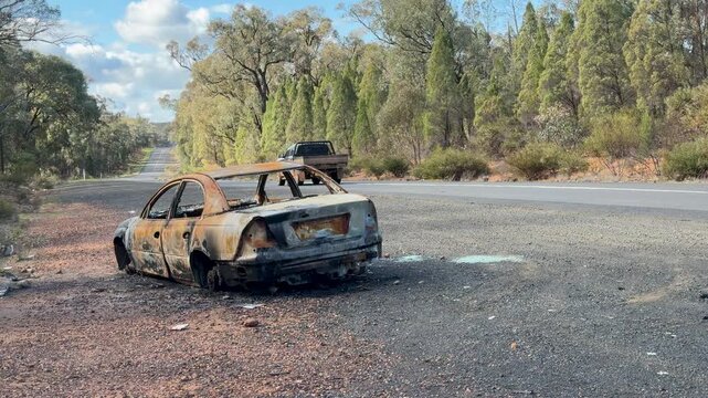 Burnt Car Wreckage Abandoned on Roadside in Australian Outback Bushland