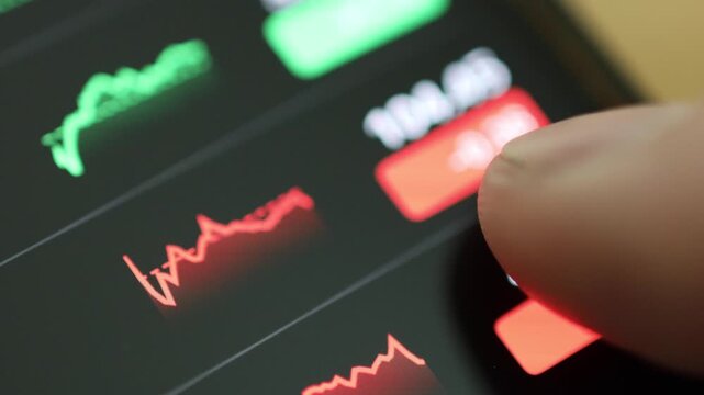 Horizontal 4K video showing a hand swiping across a mobile screen to switch between different stock company charts and performance graphs