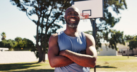 Pride, portrait or black man on basketball court with arms crossed, practice or fitness hobby on weekend. Active, happy or mature person with confidence, hoop sport or training in outdoor game. © peopleimages.com