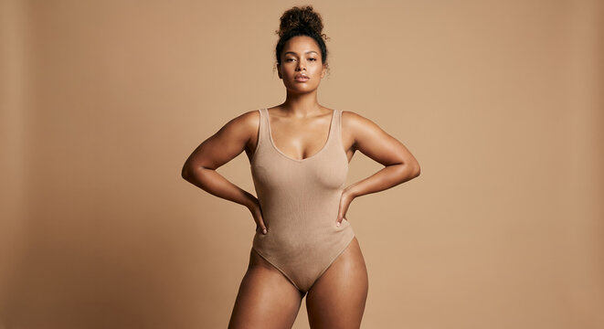 Confident woman with hands on hips facing the camera
