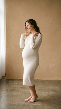 Pregnant woman in ribbed dress in soft natural light