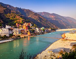 Fototapeta premium A vibrant scenic view of a river cutting through a valley with mountains. Colorful buildings line the riverbank