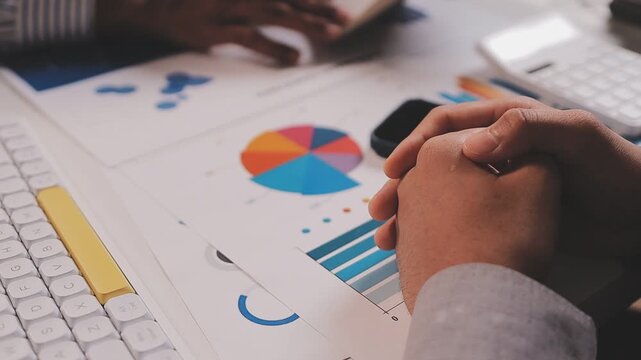 Two busy business men investors doing financial trading market data analysis. Male advisor and analyst consulting about stock exchange investing pointing at chart on laptop computer working in office.