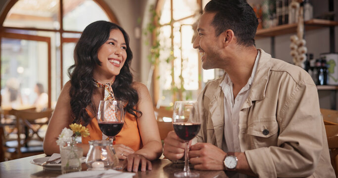 Happy, conversation and couple with wine in restaurant for date, celebration and romantic dinner together. Fine dining, love and man with woman with alcohol for talking, anniversary and relationship