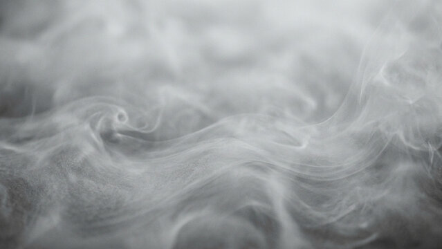 Smoke swirls rise in ethereal gray plumes, creating a soft and moody atmospheric texture that fills the frame with gentle, flowing patterns of translucent vapor.