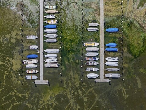 Drought on Lake Constance. The marina of Mannenbach-Salenstein in the canton of Thurgau is almost completely dry. Boats are dry at the dock and can no longer get into the water. aerial view. Mannenbach-Salenstein, Canton of Thurgau, Switzerland