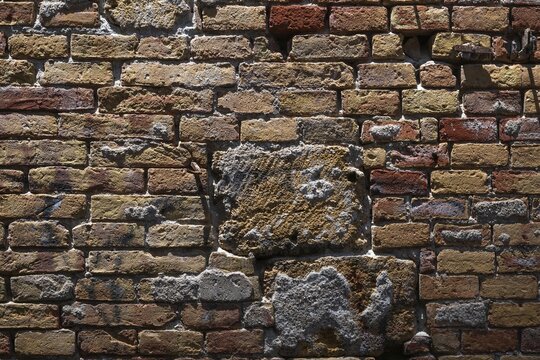 Close-up of an old brick wall with different colors and scuffs, Palermo, Sicily, Italy