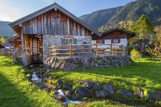Historic Schleifm&uuml;hle, water mill, in the village in spring, Ohlstadt, Loisach Valley, The Blue Land, Upper Bavaria, Bavaria, Germany