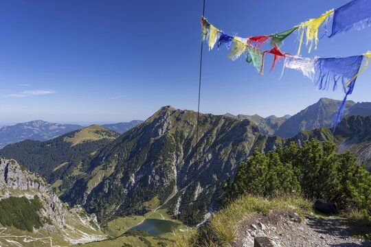 Panorama from the summit of Geissalphorn, 1953m, prayer flags flying at the summit cross, Unterer Gaisalpsee, behind it the Entschenkopf, 2043m, Allg&auml;u Alps, Allg&auml;u, Bavaria, Germany