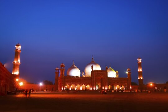Lahore, Pakistan - 24th october, 2024: Badshahi mosque Lahore timelapse zoom in day to night transition glowing domes minarets courtyard lights historic mughal architecture pakistan landmark twilight