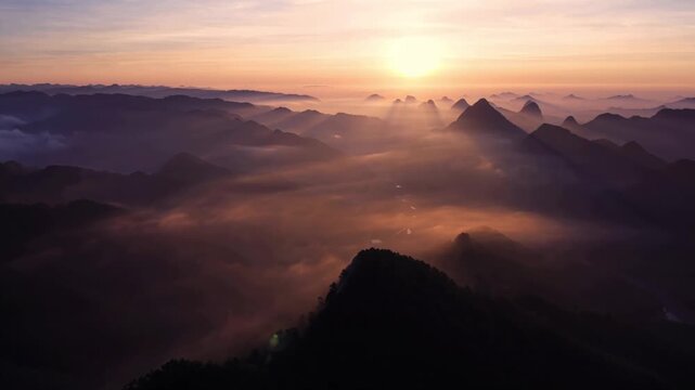 Golden Sunrise Above the Clouds with Mountain Silhouettes