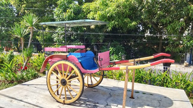 Colorful Traditional Horse Cart Monument Display in a Tropical Garden