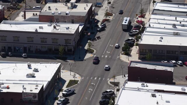 Aerial close up of commercial street intersection in Cle Elum Washington with multistory brick and stucco buildings lining the streets