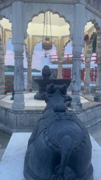 Black Nandi Statue Facing Shivling in Temple During Evening