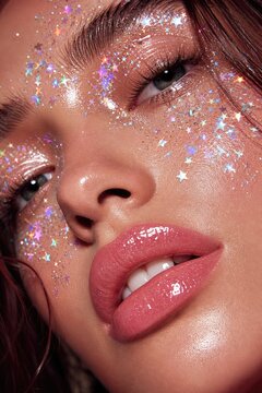 Glamorous woman with shimmering glitter makeup and bold red lipstick puckering lips, festive party or celebration aesthetic, close-up portrait with starry sparkle effects on skin