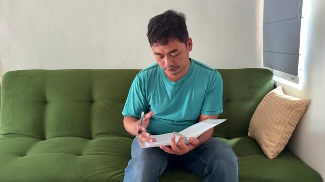 Young man write on notebook pages at home. Perfect for study, reading, education, concentration, knowledge, and personal development themes.