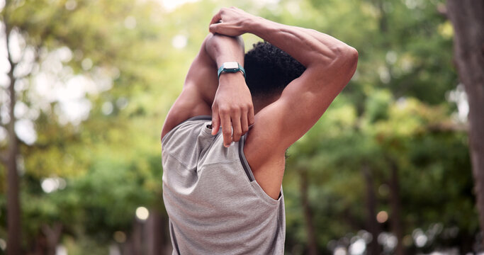 Athlete, exercise and man stretching at park for post fitness, muscle tension relief and wellness. Active, back and runner with arm warm up in nature for cardio recovery, physical activity and health