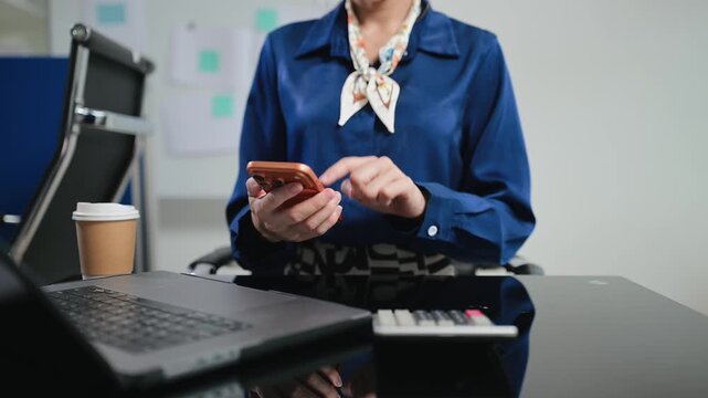 Women counting coins on calculator taking from the piggy bank. hand holding pen working on calculator to calculate on desk about cost at office.