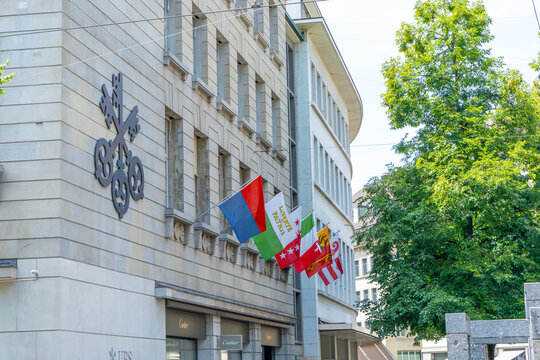 UBS sign on the street wall of UBS office building with flags entrance. UBS AG Swiss global financial services company. Zurich, Switzerland - June 23, 2026