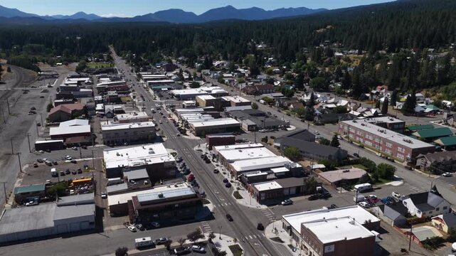 Aerial of Cle Elum town center and residential area in Washington in summer with commercial buildings lining the main street