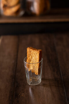 Rusk kept in an empty tea glass on a table