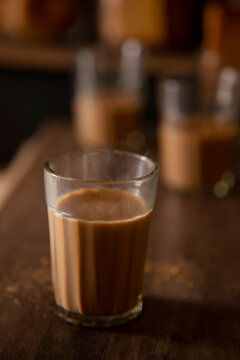 Close up of a glass half filled with tea kept on table