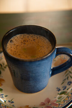 Cup filled with hot tea kept on a saucer