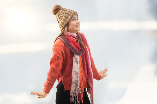 Young woman wearing a cap and muffler enjoying winter season 