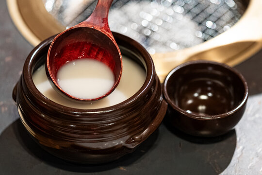 Traditional Japanese Hot Beverage Served in Ceramic Pot with Wooden Ladle