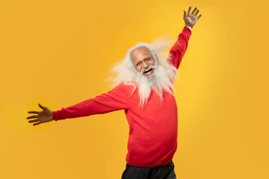 A HAPPY OLD MAN RAISING HANDS IN HAPPINESS