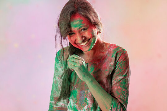 Woman smiling with gulal on her face on the occasion of Holi