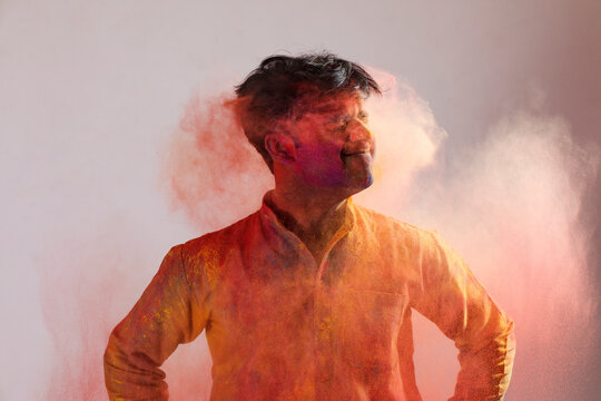 Man shaking his head to get the color out of his hair on Holi