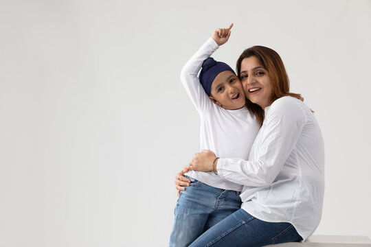 A SIKH MOTHER AND SON HAPPILY PLAYING AND SPENDING TIME TOGETHER