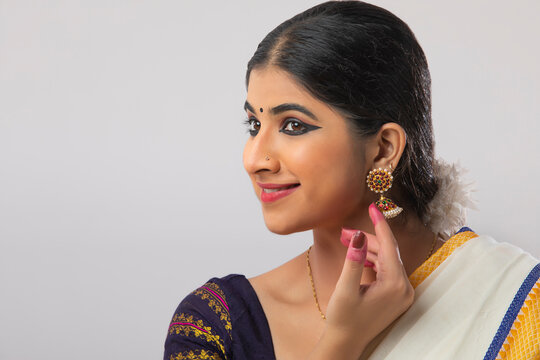 Indian classical dancer showing her earrings