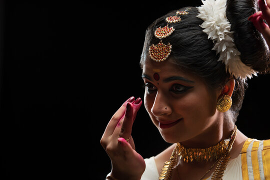Mohiniattam dancer admiring the beauty of a plucked flower