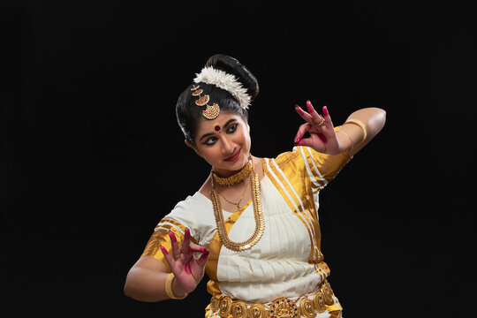 Mohiniattam dancer portraying a beautiful garland of flowers being woven