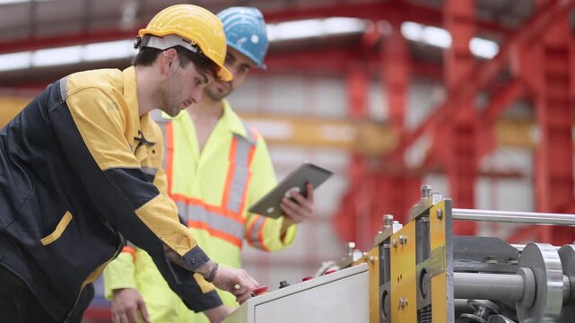 Engineering and production teams inspect automated factory equipment, discussing preventive maintenance, analyzing machine performance, resolving technical challenges, improving manufacturing producti