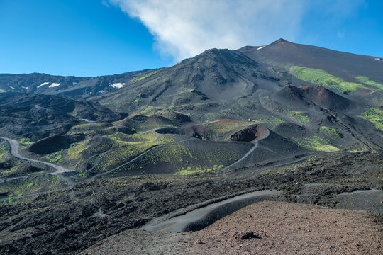 Roads through dramatic Volcanic terrain with cinder cones and craters, Mount Etna, Sicily, Italy