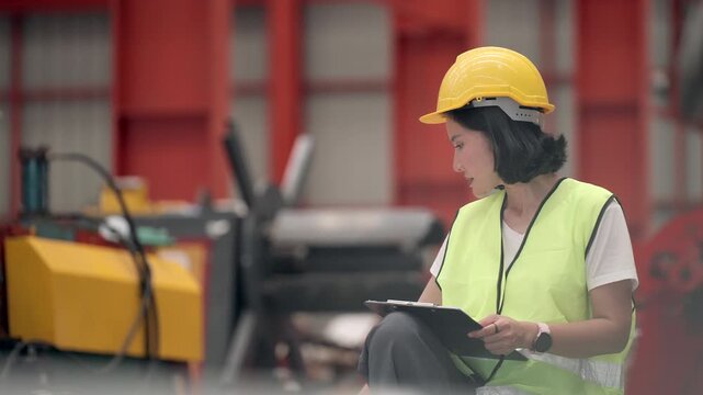Female industrial engineers working in production operators, inspecting machinery, repair solutions, optimizing manufacturing systems, preventing equipment failures, and production process improvement