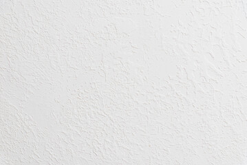 Fototapeta premium White textured plaster wall background with copy space. Minimalist white stucco surface banner featuring a rough structural pattern.